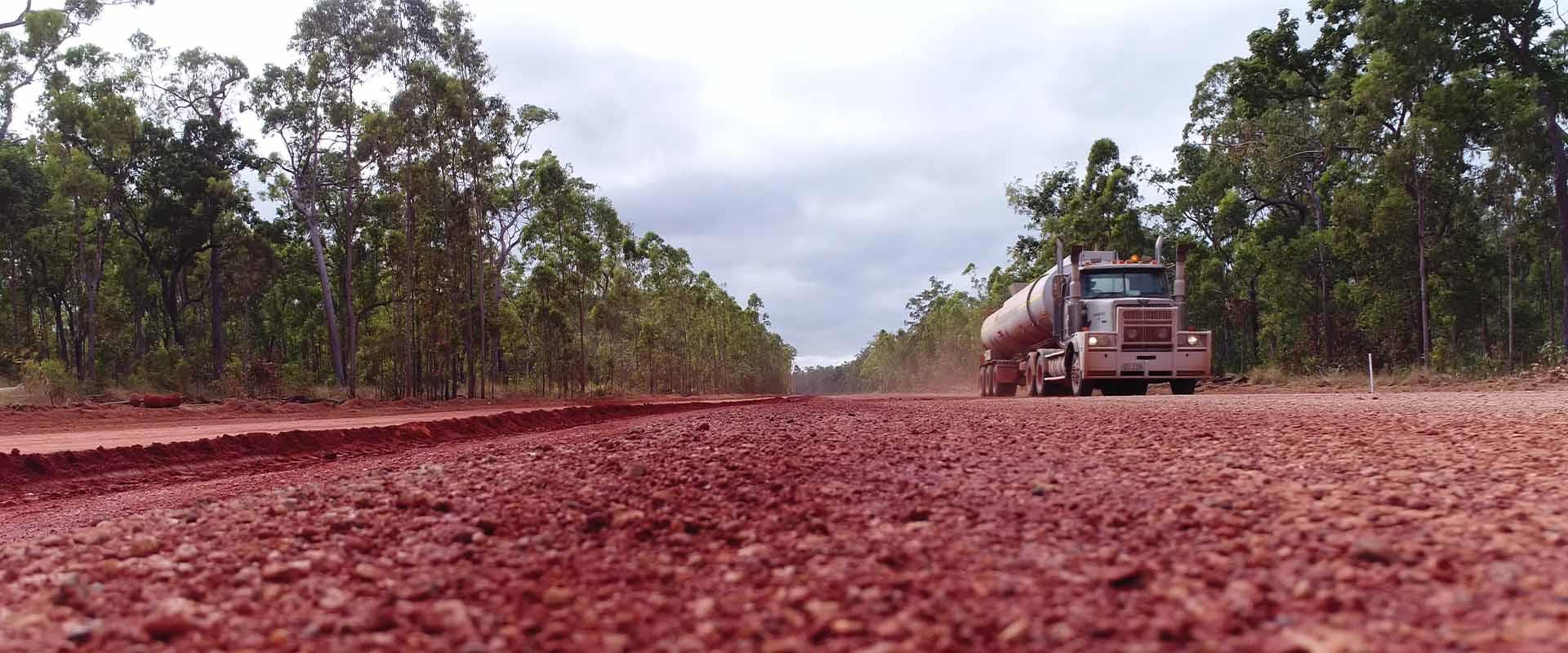 truck driving along dirt road